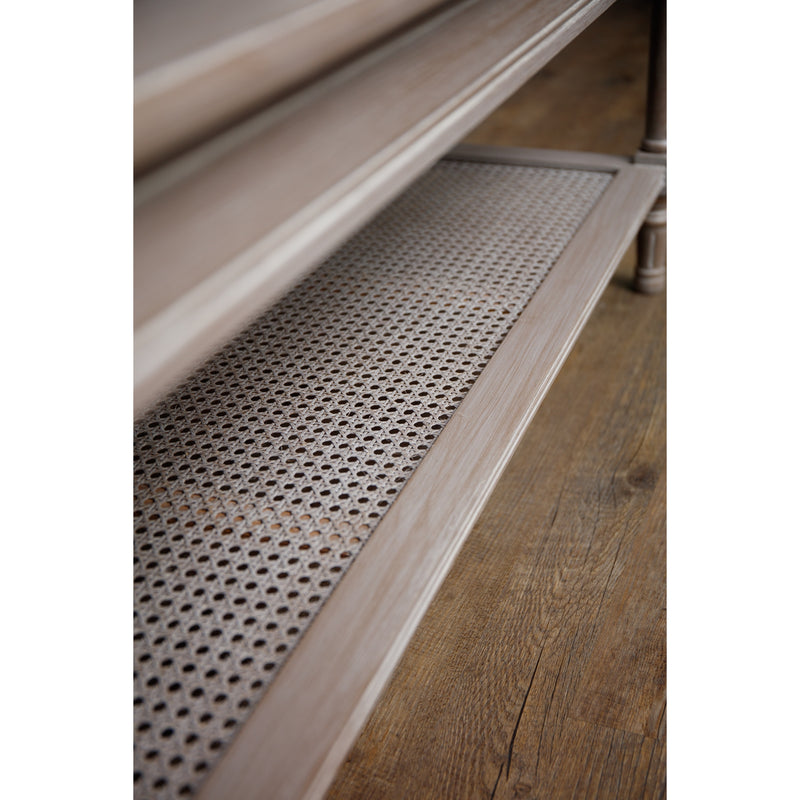 Close up of the bottom rattan shelf of the wooden coffee table