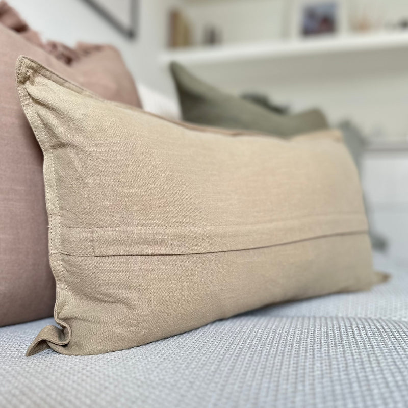 Back of the beige rectangle cushion showing the zip hidden under a fold in the centre of the cushion