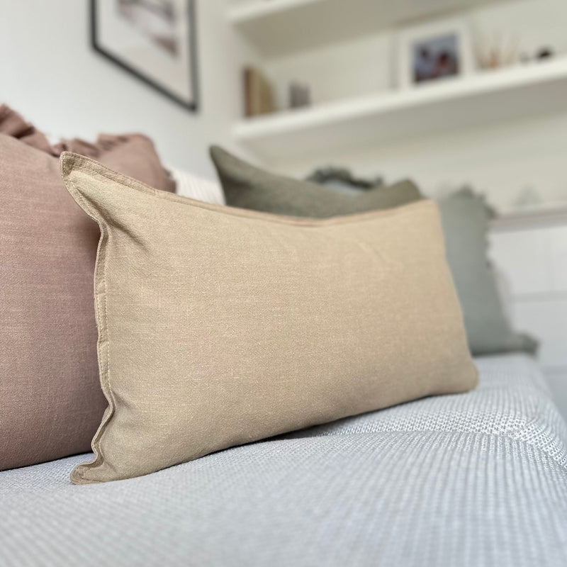 Beige Rectangle Linen Cushion sat on a ream sofa