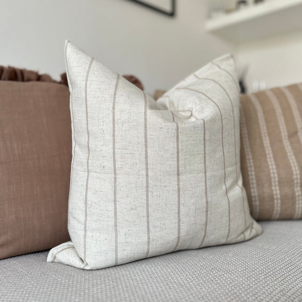 square cream cushion with vertical repeating thin brown stripes