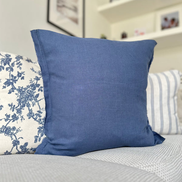 navy blue square cushion with a weathered edge.