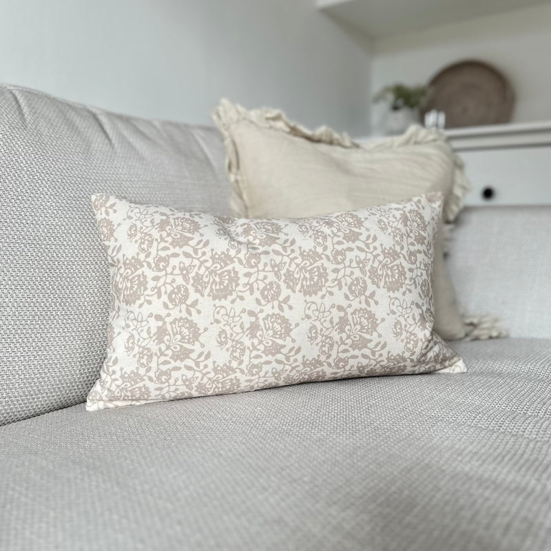 rectangle cream cushion with a beige floral print. 