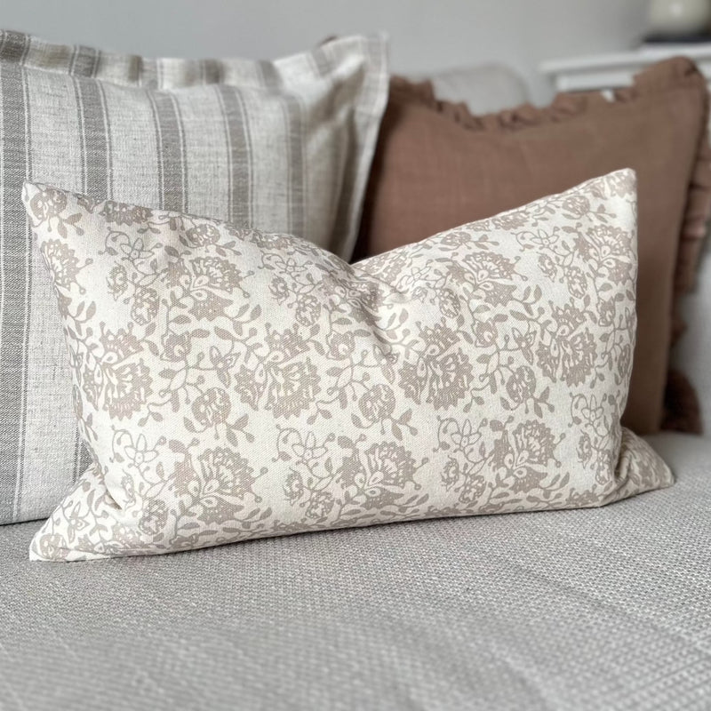 rectangel cream cushion with a delicate beige floral all over pattern.