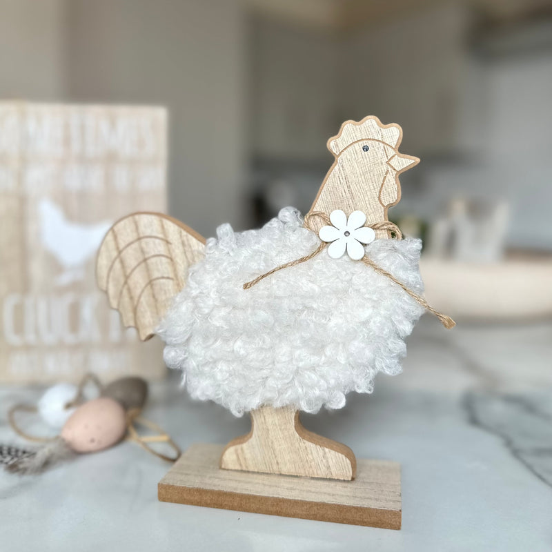 decorative wooden chicken with white fluffy body and a wooden daisy necklace