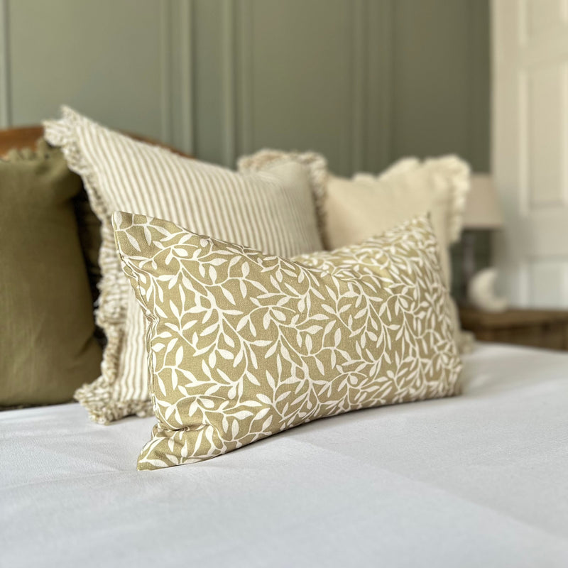 rectangle cushion with an olive all over colour and a cream leaf motif print.