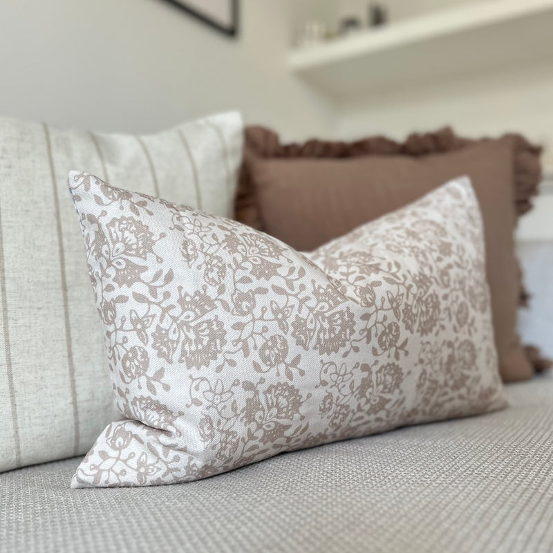 close up of the rectangle cream cushion with brown all over floral pattern cushion.