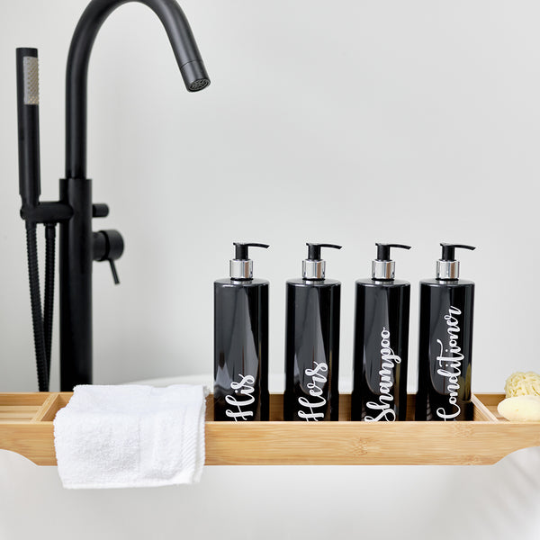 Four 500ml black reusable dispenser pump bottles with labels with His, Hers Conditioner and Shampoo besides a matching sink