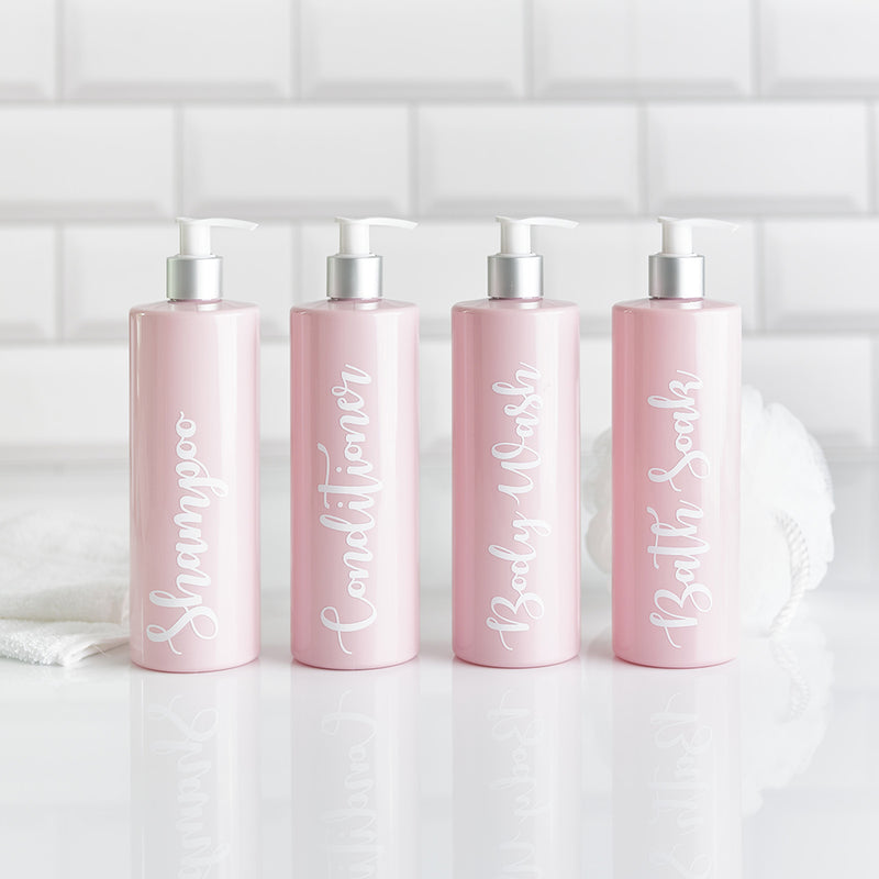 Four pink soap dispenser bottles with customisable wording for shampoo conditioner body wash and bath soak