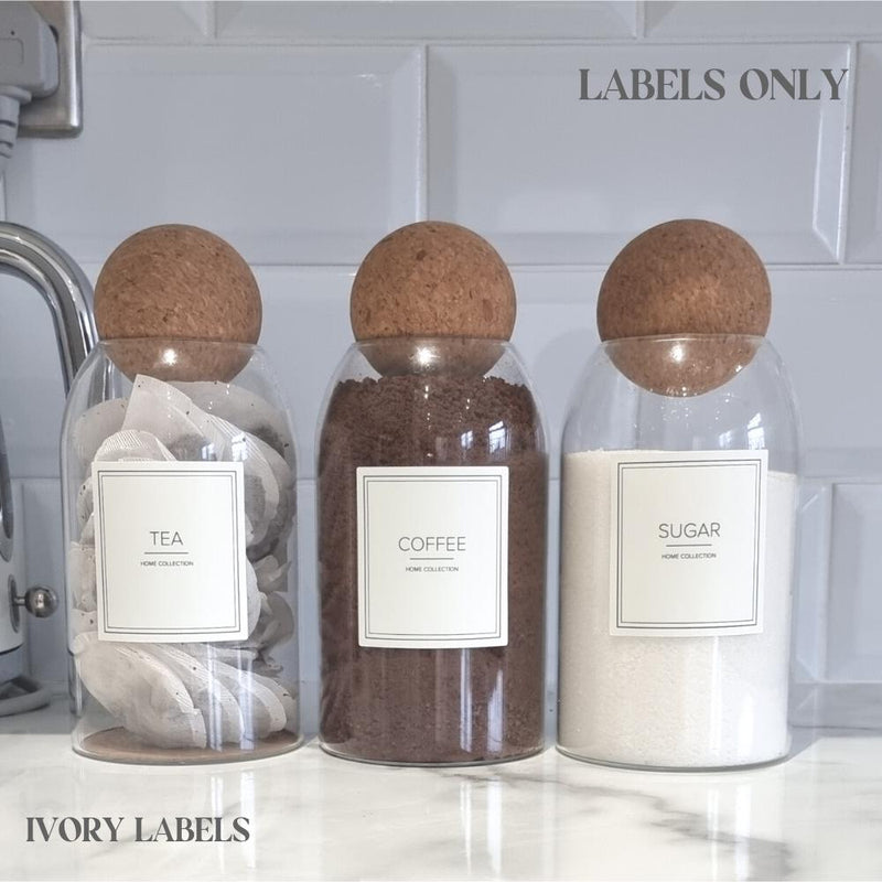 square cream labels stuck to glass jars saying tea coffee sugar in bold text