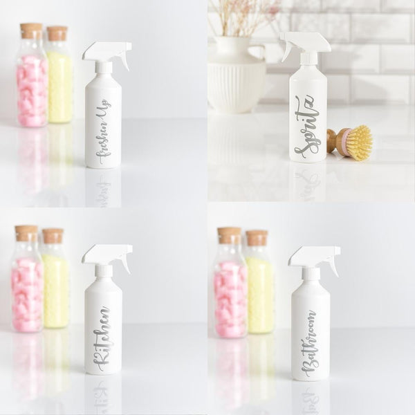 Four white plastic spray bottles with grey labels attached. The labels read 'Spritz', 'Freshen Up', 'Bathroom', and 'Kitchen' . These customisable bottles are perfect for organising and storing your favourite cleaning solutions in different areas of your home.