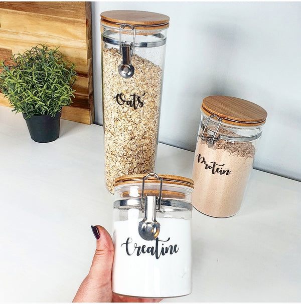 Three glass jars with custom personalised wording for labelling, showing all three sizes.